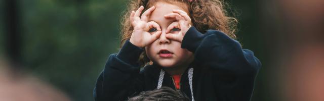 Meisje gebruikt haar handen als verrekijker